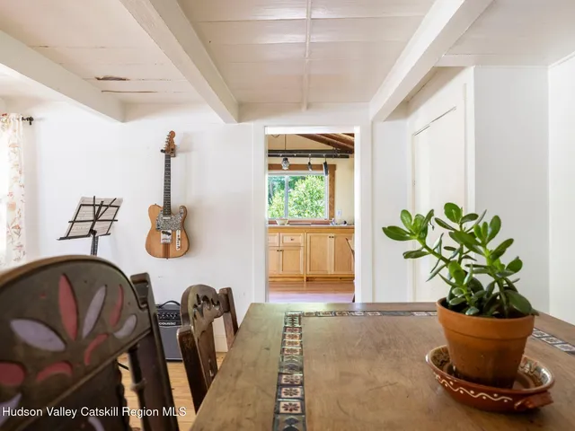 a view of a dining room with furniture and a potted plant