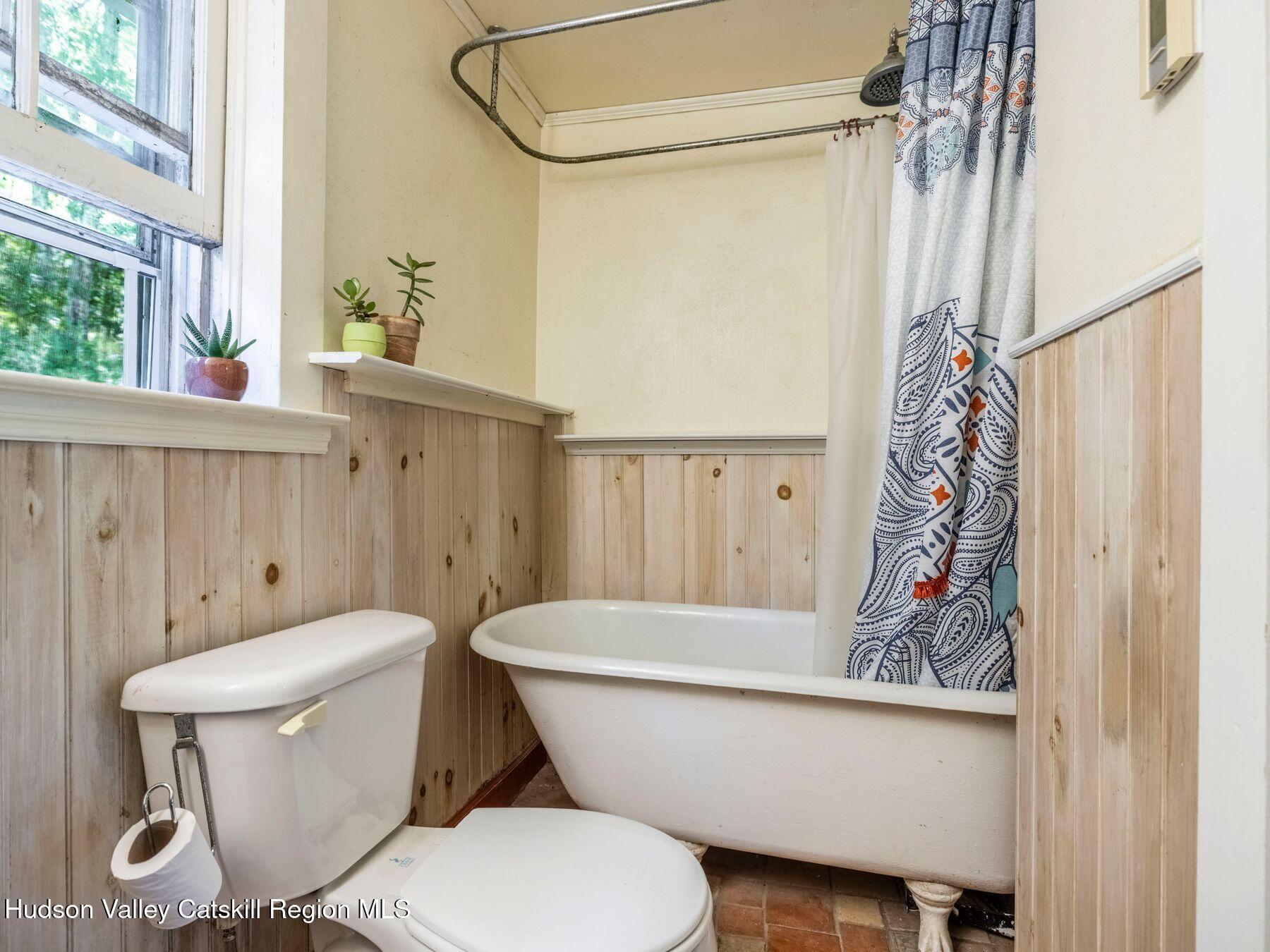 452 County Road 2 Accord, NY 12404 - Photo 28 of 45 a white toilet sitting next to a shower curtain