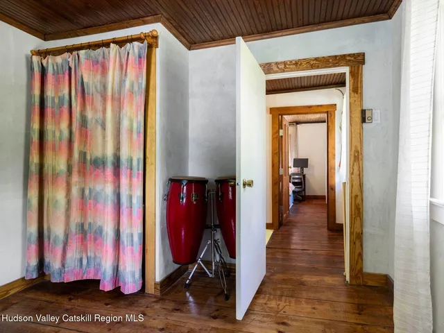 a view of a room that has a window and a dresser