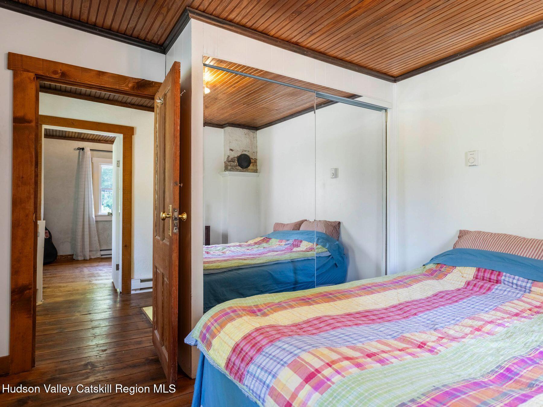 452 County Road 2 Accord, NY 12404 - Photo 32 of 45 a bedroom with a bed and wooden floor