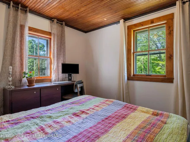 a hallway with a large window and book shelf