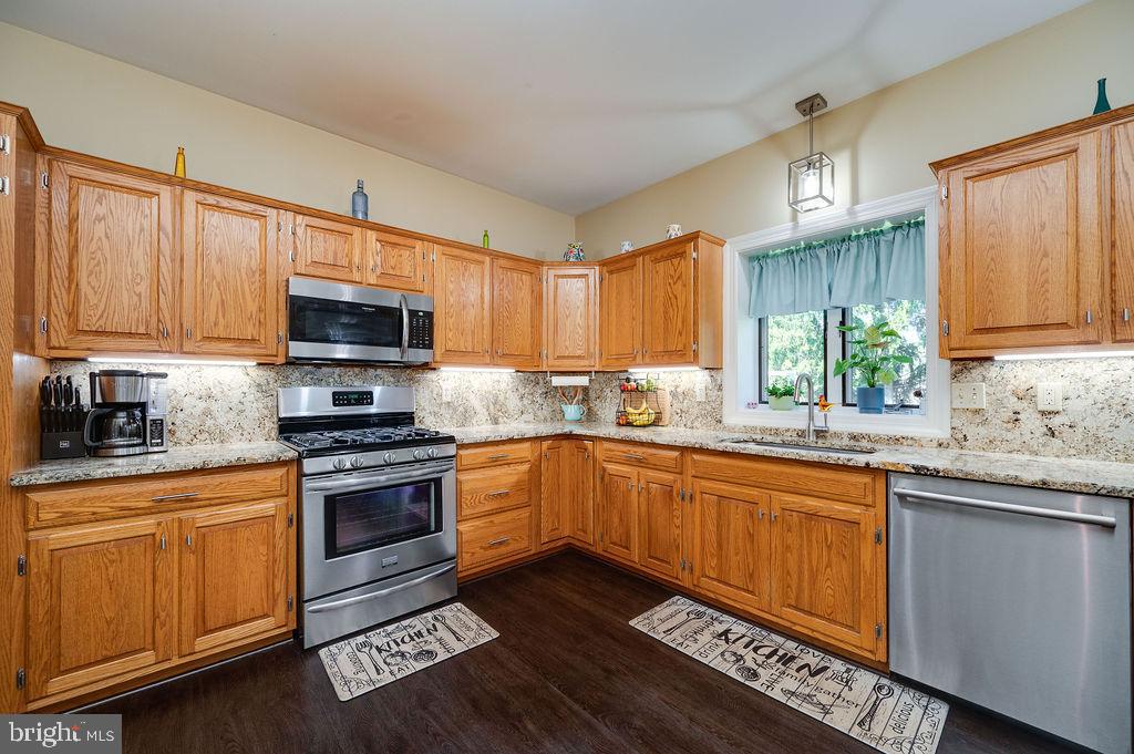 24 Sycamore Drive Reading, PA 19606 - Photo 18 of 56 a kitchen with stainless steel appliances wooden cabinets and a stove top oven