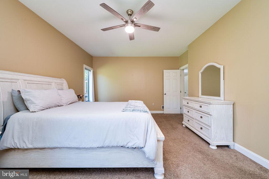 24 Sycamore Drive Reading, PA 19606 - Photo 26 of 56 a bedroom with a bed and a chandelier