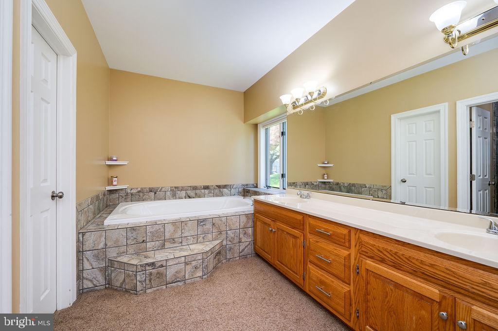 24 Sycamore Drive Reading, PA 19606 - Photo 27 of 56 a bathroom with a tub sink and mirror