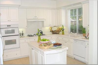 27 Alconbury Way Novato, CA 94949 - Photo 9 of 10 a kitchen with granite countertop white cabinets and white appliances