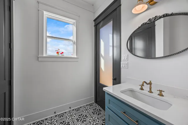 a hallway with dining room and chandelier