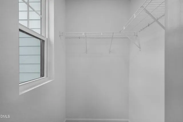 a view of an empty room and a window