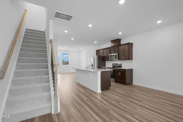 a view of kitchen with sink microwave and refrigerator