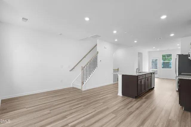a view of a living room with wooden floor