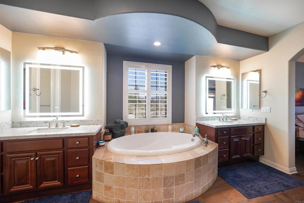 22963 Stokes Road Ramona, CA 92065 - Photo 32 of 57 a spacious bathroom with a tub sink and mirror
