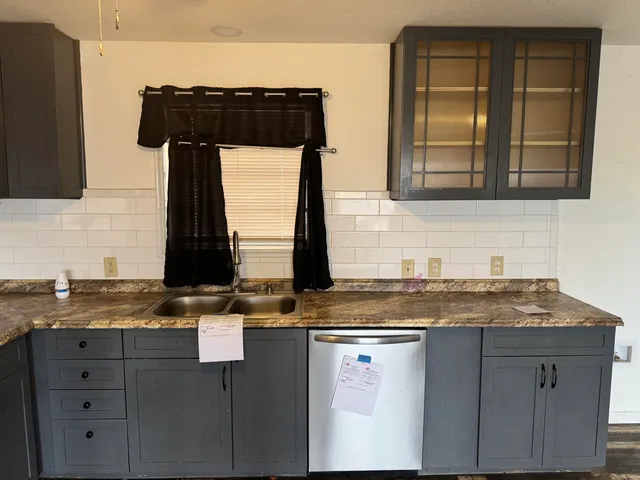 a kitchen with a sink and a window