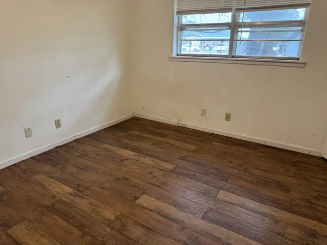 a view of a room with wooden floor
