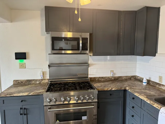 a kitchen with a stove and a sink