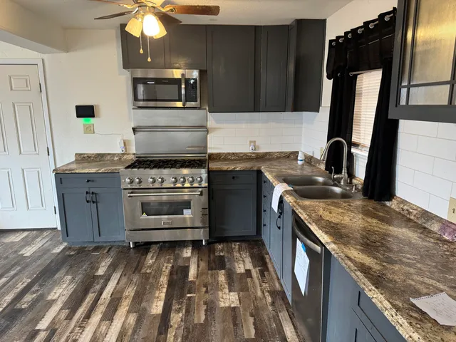 a kitchen with a stove and a sink