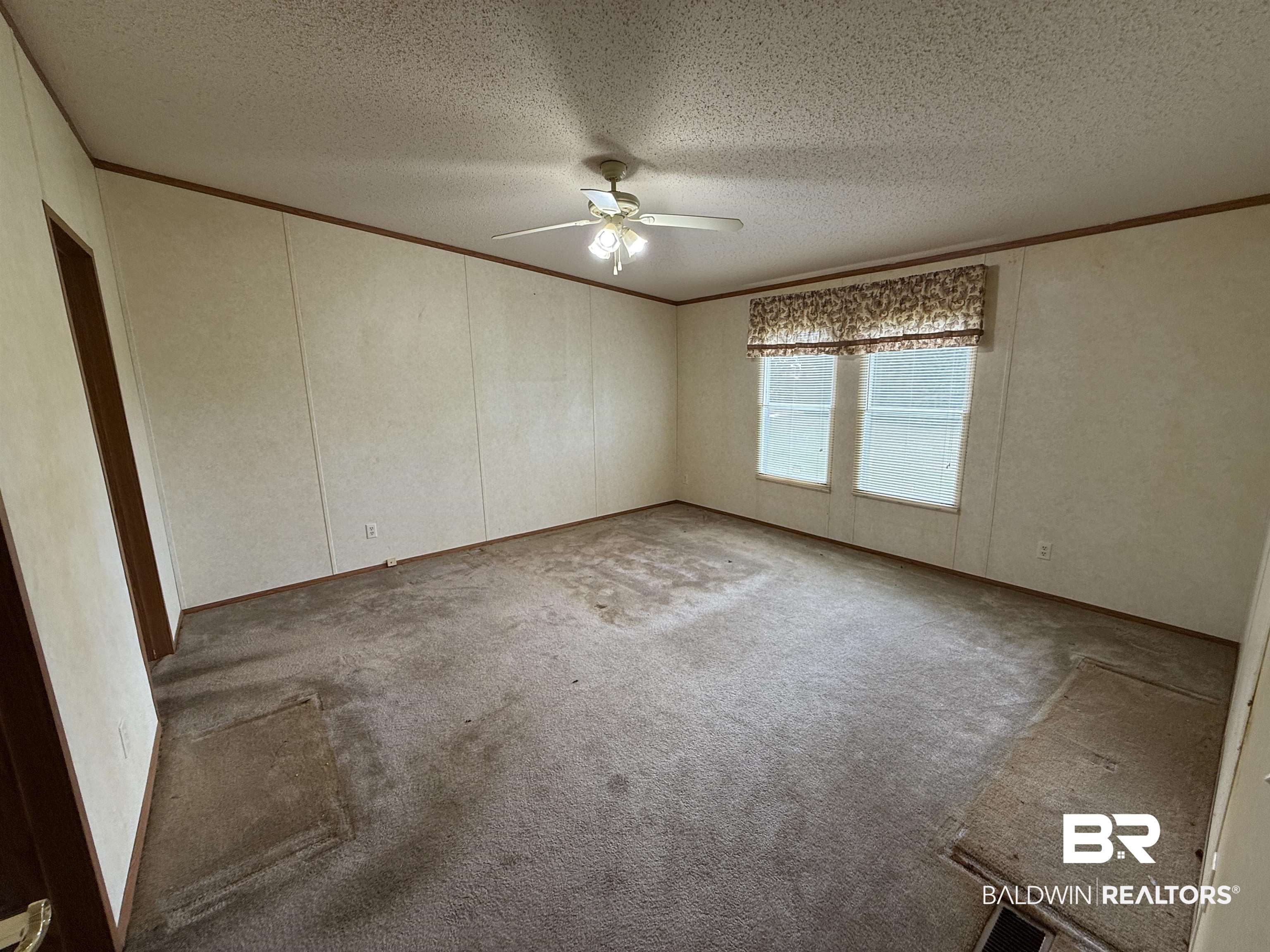 14402 County Road 55 Foley, AL 36535 - Photo 12 of 20 Carpeted spare room with ornamental molding, a textured ceiling, and ceiling fan