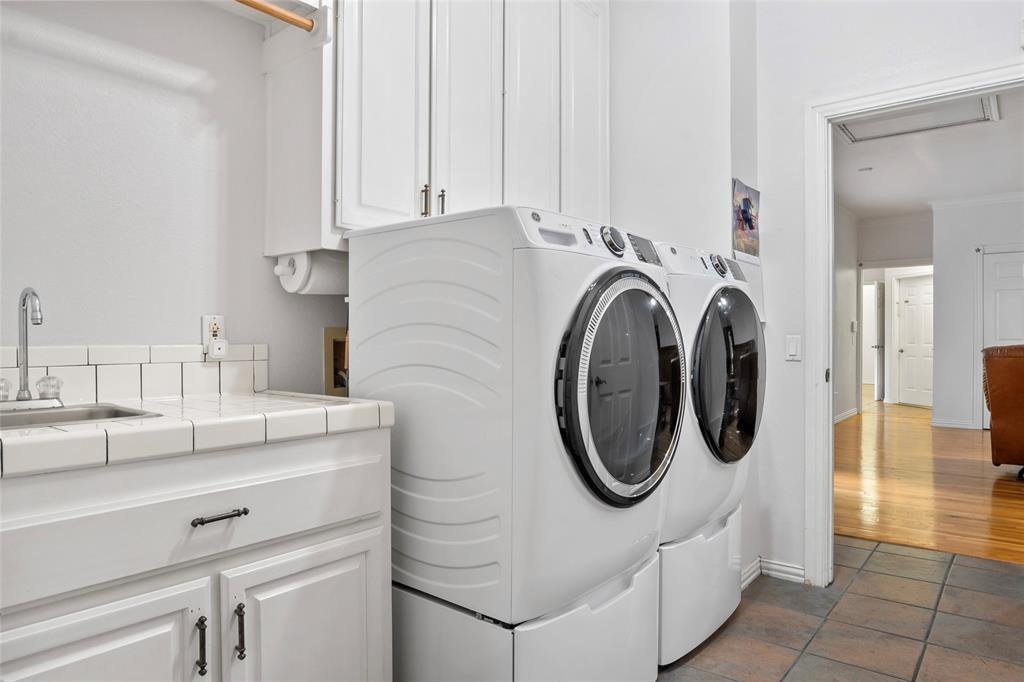 3650 Mt Zion Road Midlothian, TX 76065 - Photo 19 of 38 This Laundry room has ample space and is located between the bedrooms and the game room. This laundry room has a wonderful tiled sink area.