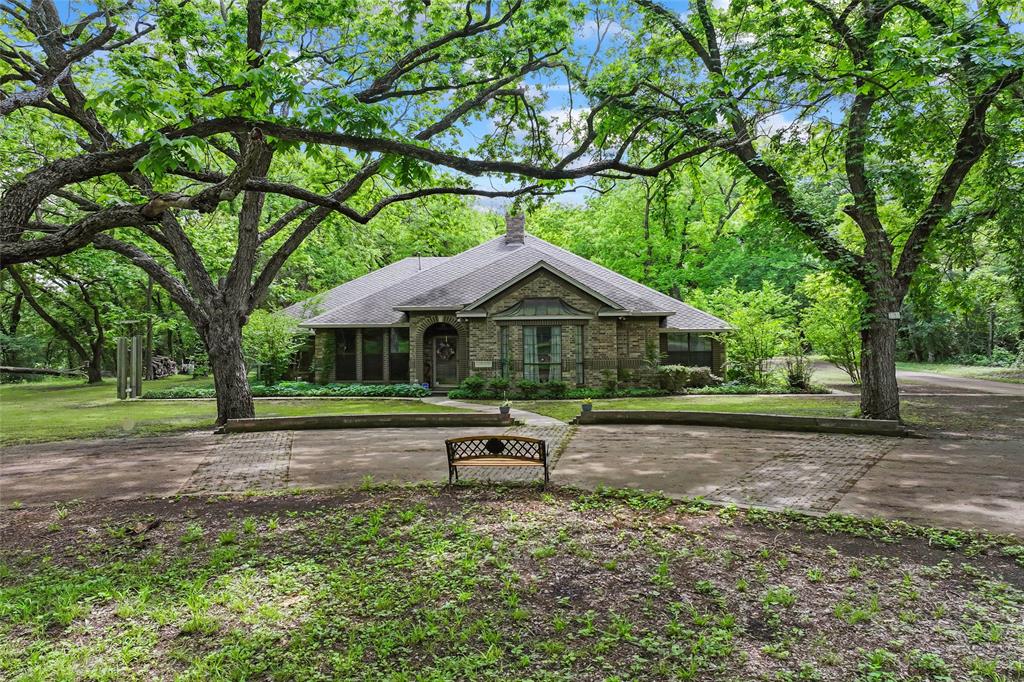 3650 Mt Zion Road Midlothian, TX 76065 - Photo 2 of 38 Front of home during the day. The sun peaking through the trees.
