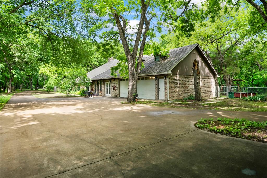 3650 Mt Zion Road Midlothian, TX 76065 - Photo 27 of 38 This photo was taken on the southeast side of the property near the metal building. This photo shows the depth of the home, and dormer windows above the garage, where the bonus room is located.