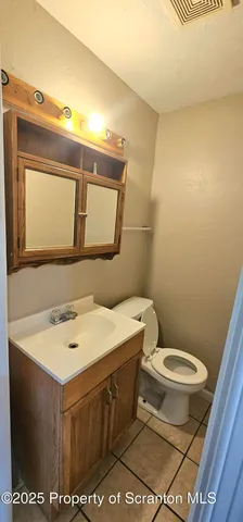 a bathroom with a sink toilet and mirror