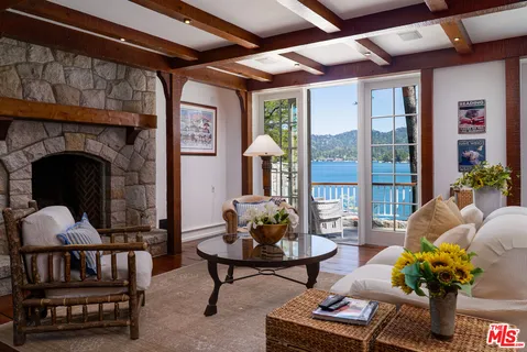 a bedroom with furniture and a large window