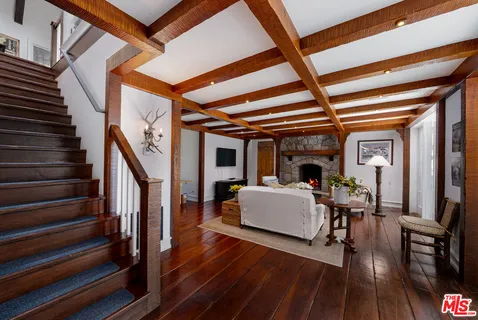 an aerial view of a house with yard porch and furniture