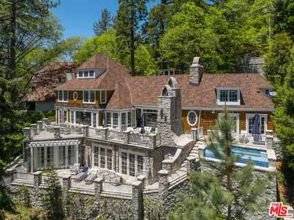 a front view of a building with lots of green space