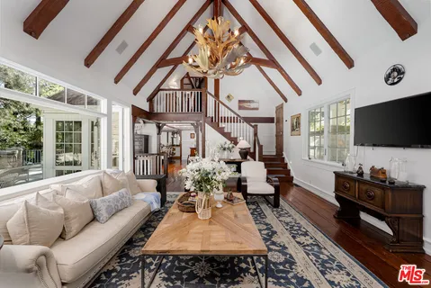 a living room with furniture fireplace and flat screen tv