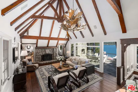a living room with furniture and a floor to ceiling window