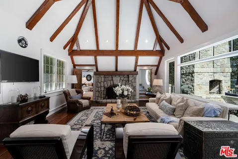 a living room with fireplace furniture and a flat screen tv