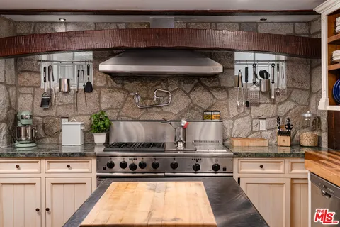 a kitchen with stainless steel appliances granite countertop a sink and cabinets