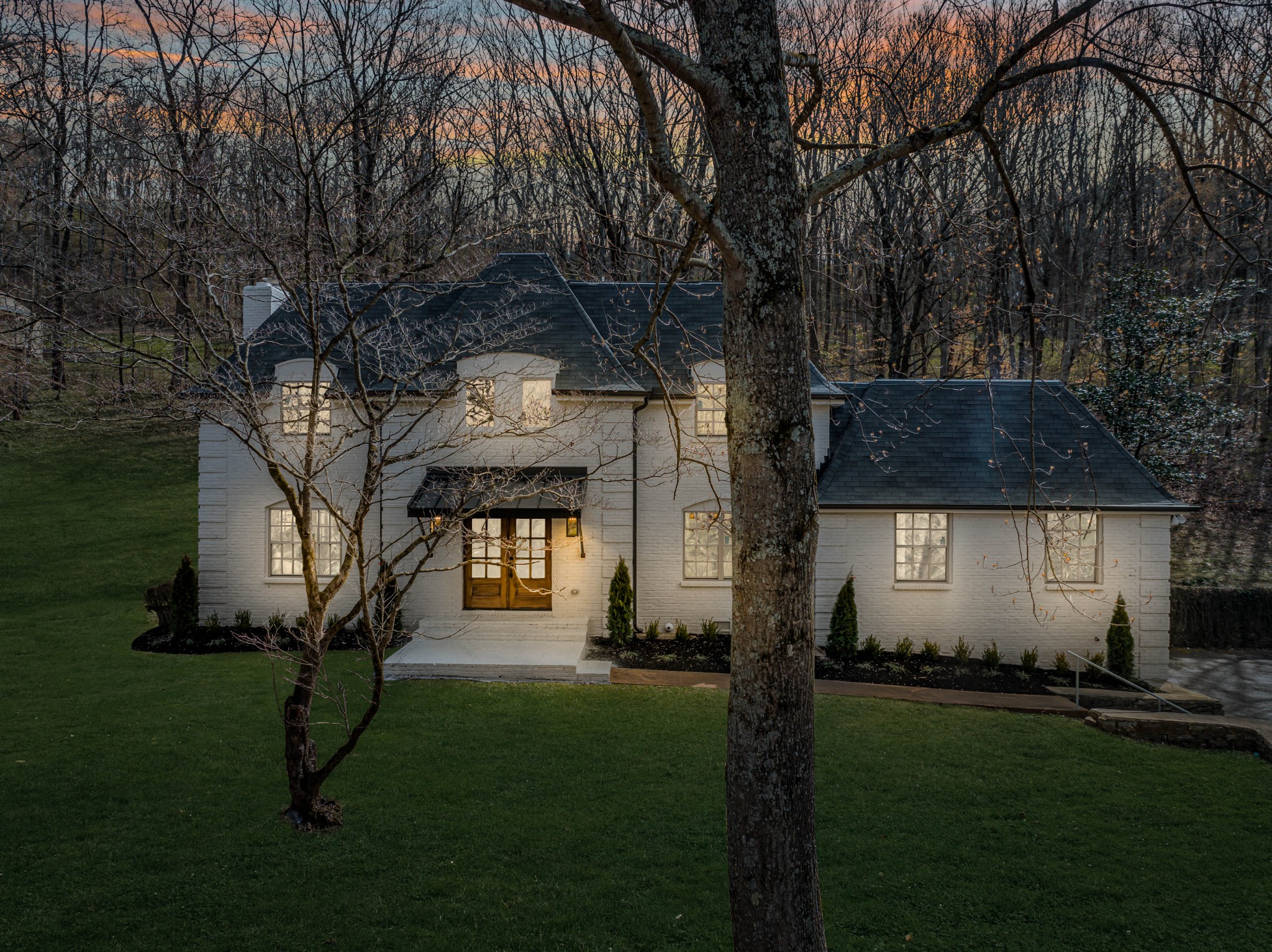 4366 Chickering Lane Nashville, TN 37215 - Photo 29 of 32 a front view of a house with a garden and trees