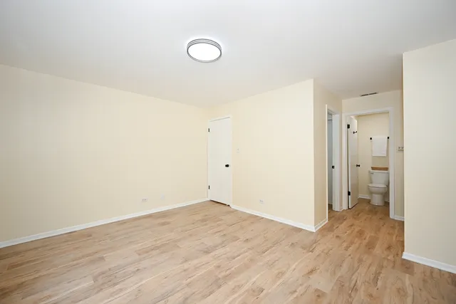 a view of a room with wooden floor