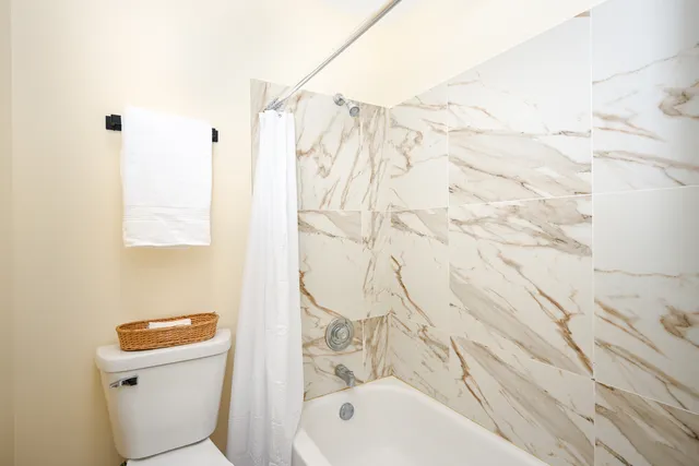 a bathroom with a toilet and a shower