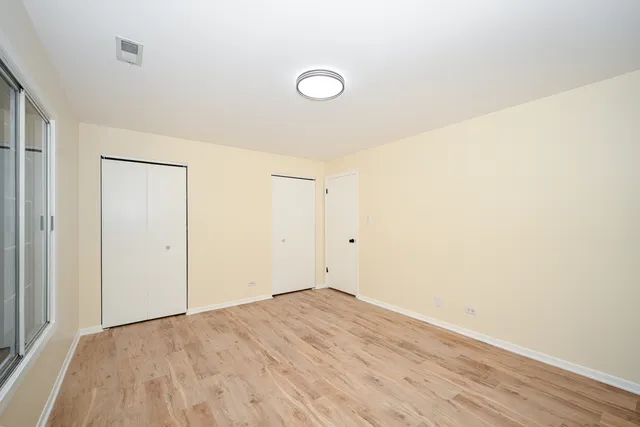 a view of a room with wooden floor and bathroom