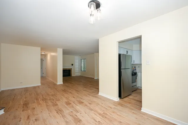 a view of a livingroom with wooden floor and a ceiling fan