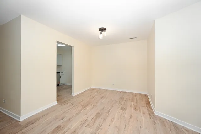 a view of a room with wooden floor