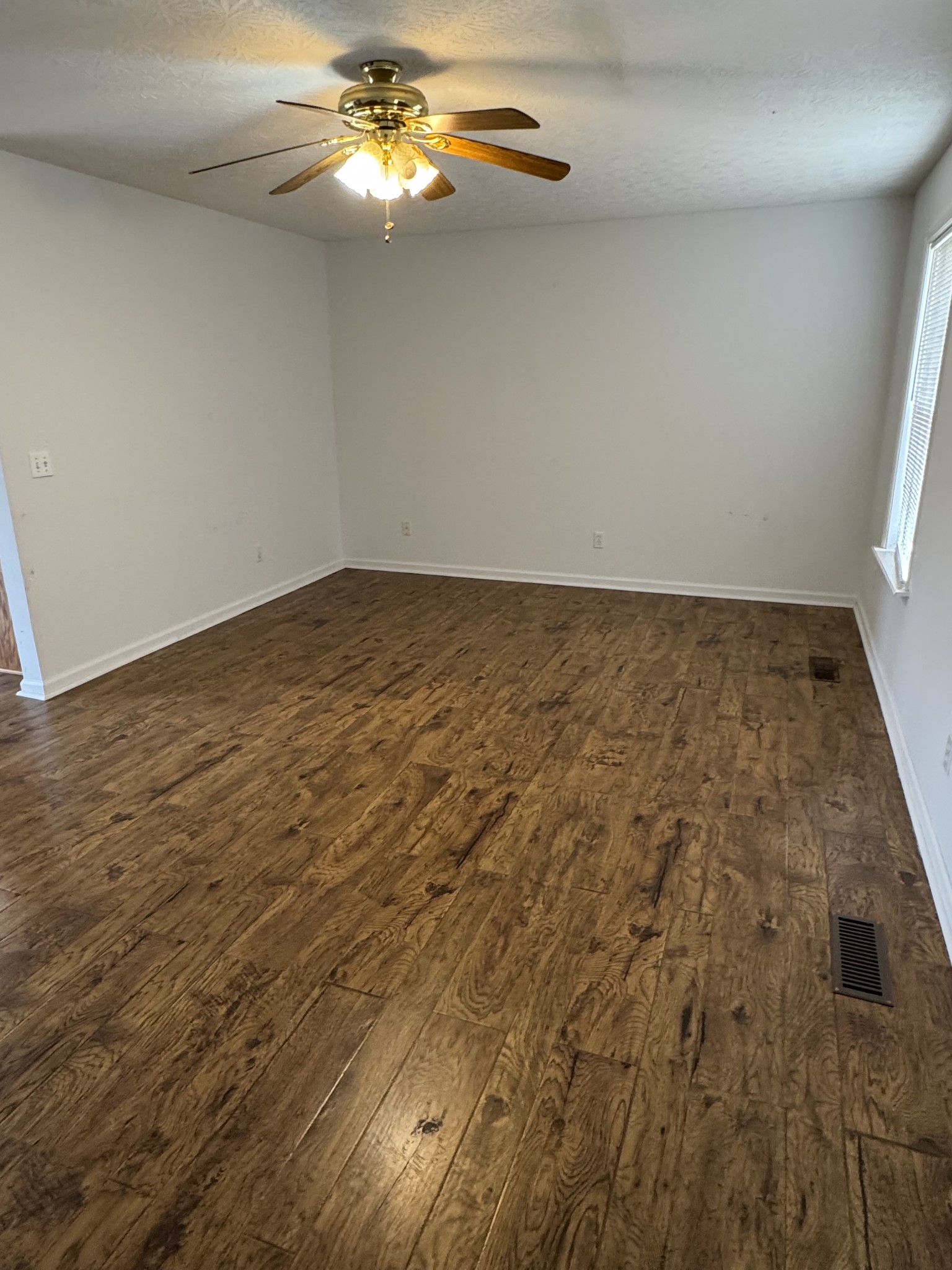 354 Spring Creek Road Lafayette, TN 37083 - Photo 5 of 14 wooden floor in empty room with window
