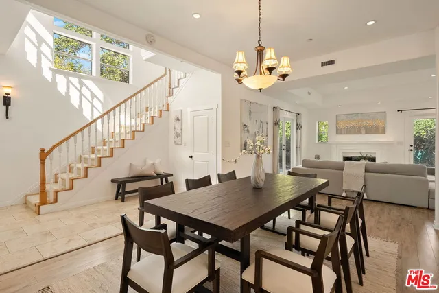 a view of a dining room with furniture and chandelier