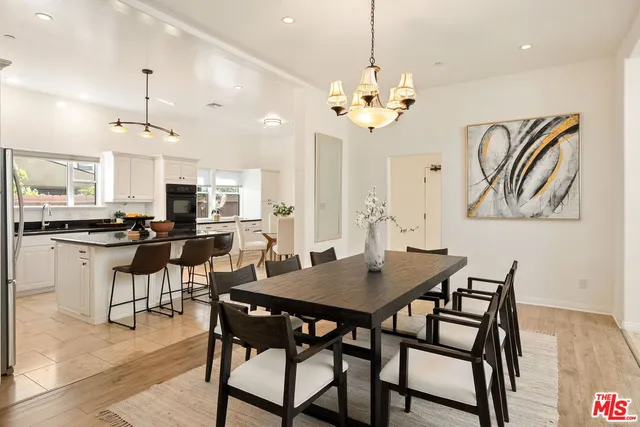 a living room with furniture fireplace and a large window