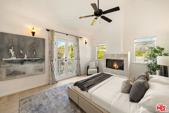 a bedroom with a large bed and a large window