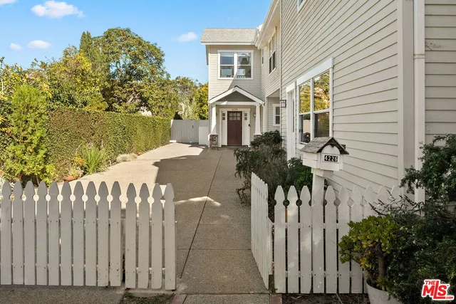 a front view of a house with wooden fence
