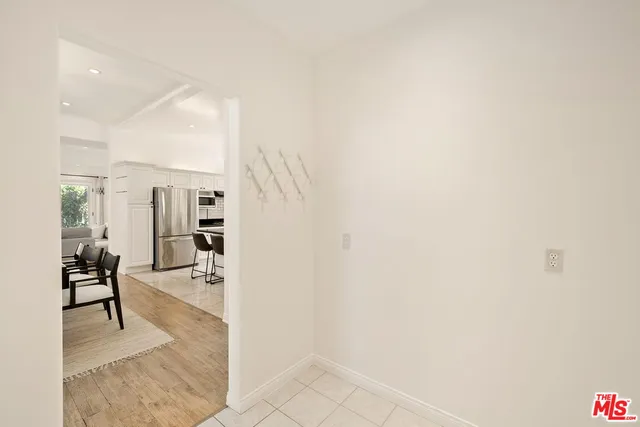 a dining room with wooden floor a chandelier a wooden table and chairs