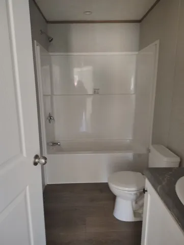 a bathroom with a toilet and a shower