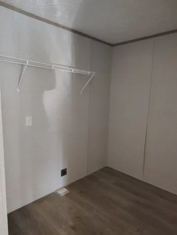 a view of a room with wooden floor