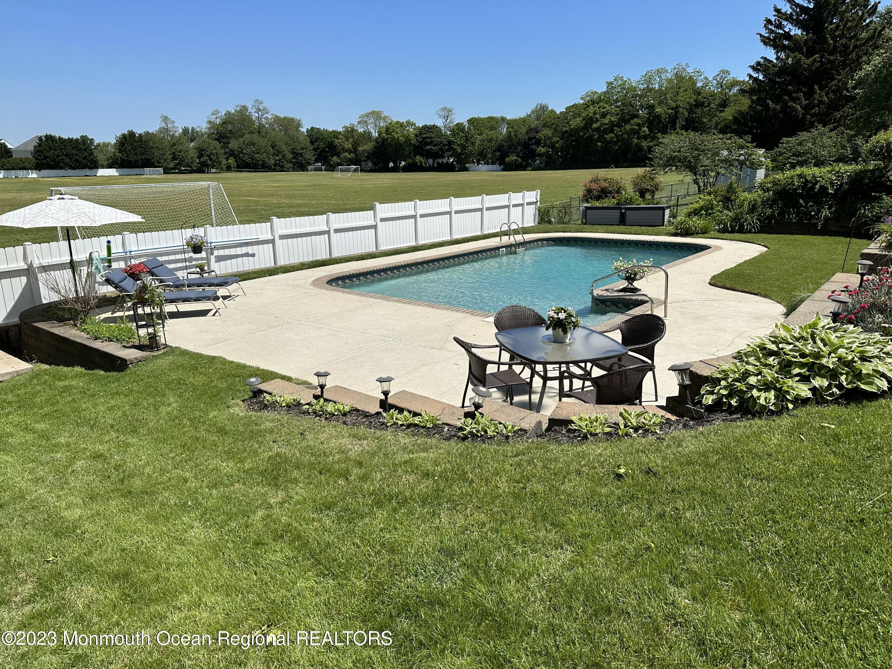 283 Edgemoor Road Belford, NJ 07718 - Photo 23 of 32 Pool with table and lounges