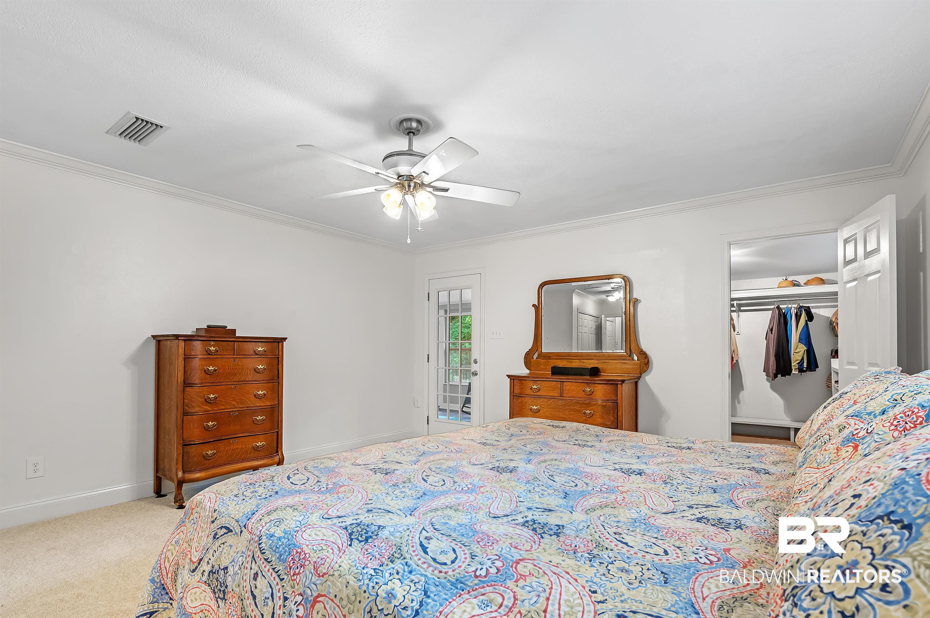 104 James Circle Daphne, AL 36526 - Photo 43 of 62 Bedroom with ornamental molding, light colored carpet, a closet, and ceiling fan