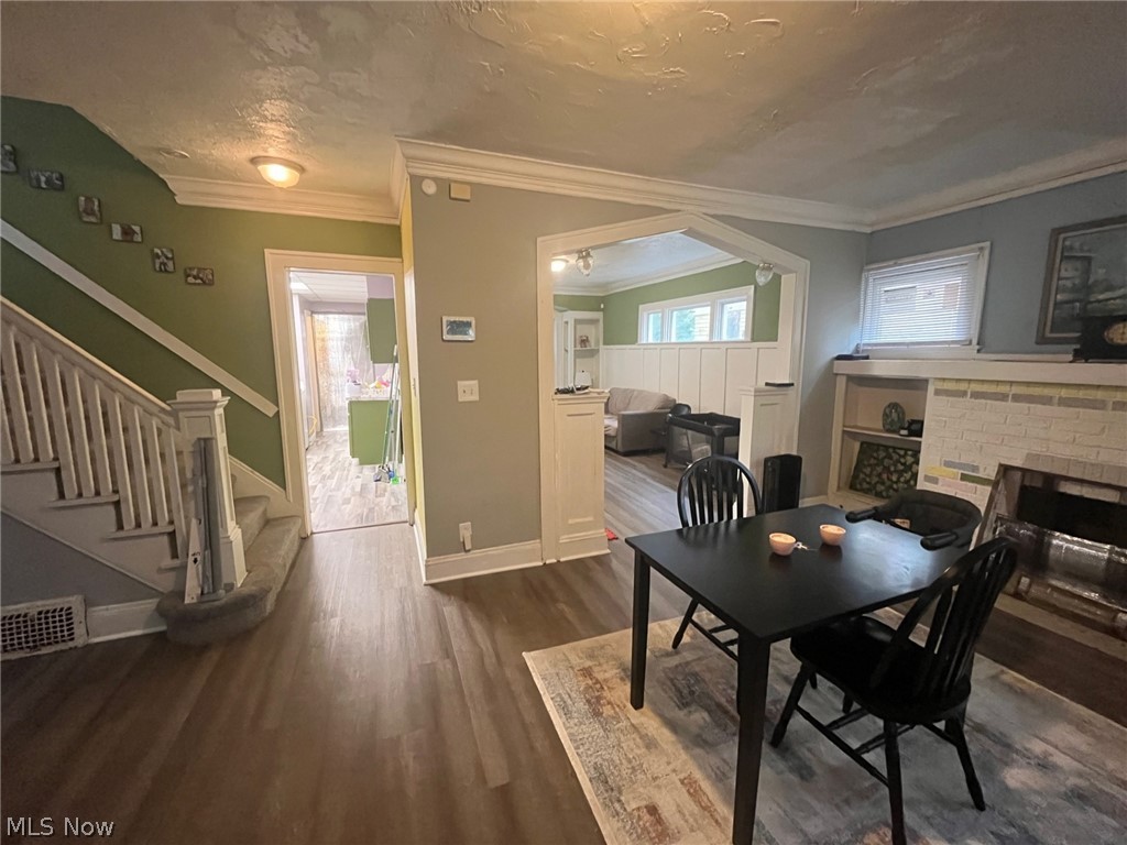 1101 Carlyon Road East Cleveland, OH 44112 - Photo 2 of 23 Interior living space featuring new flooring and a staircase with painted wood railings