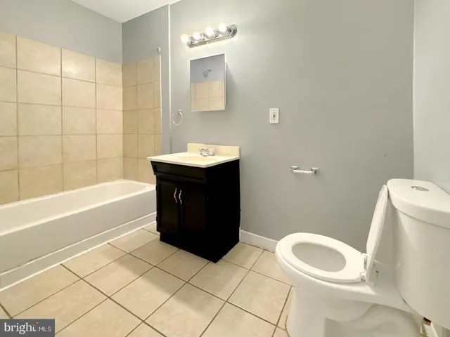a view of a kitchen with wooden floor electronic appliances and furniture