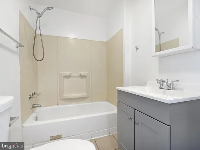 a bathroom with a sink a toilet and bathtub