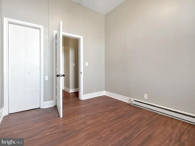 a view of a room with wooden floor